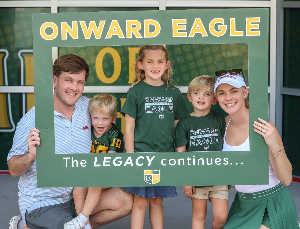 Onward Eagle family posing with the Onward Eagle frame