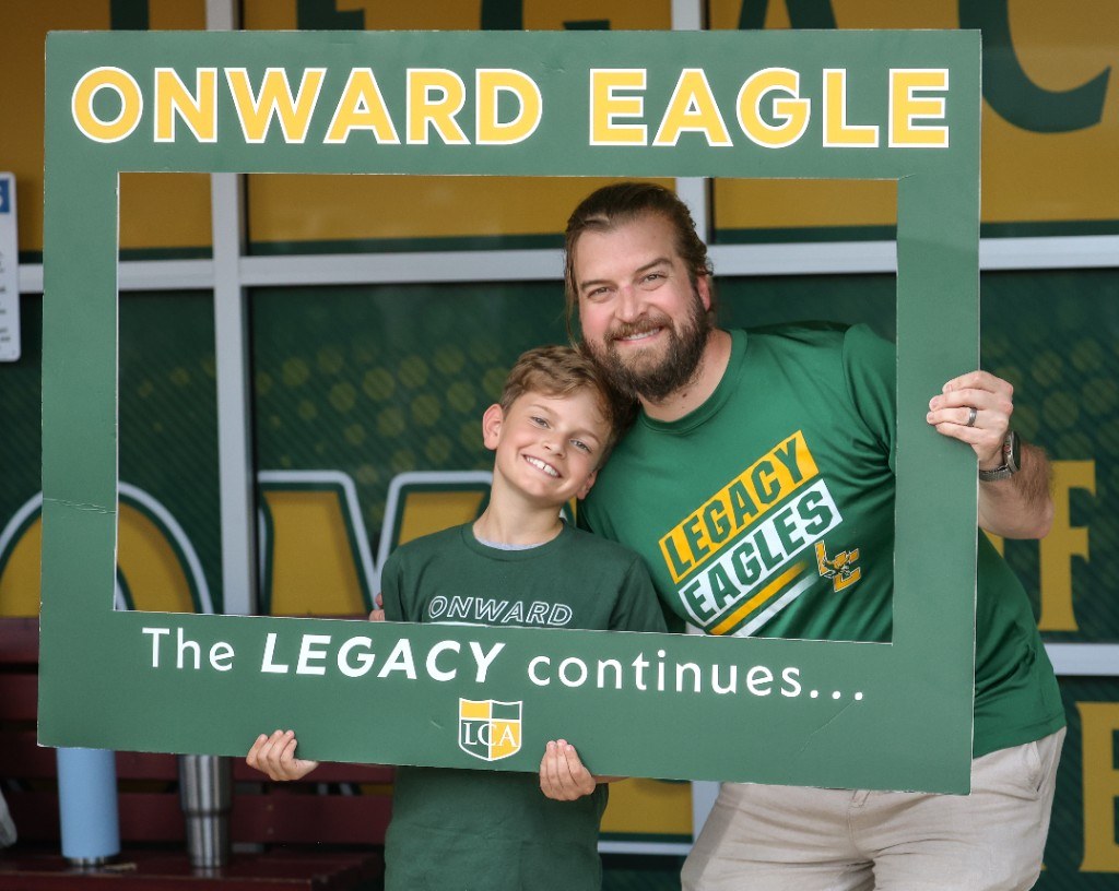 Father and son celebrating as an Onward Eagle family