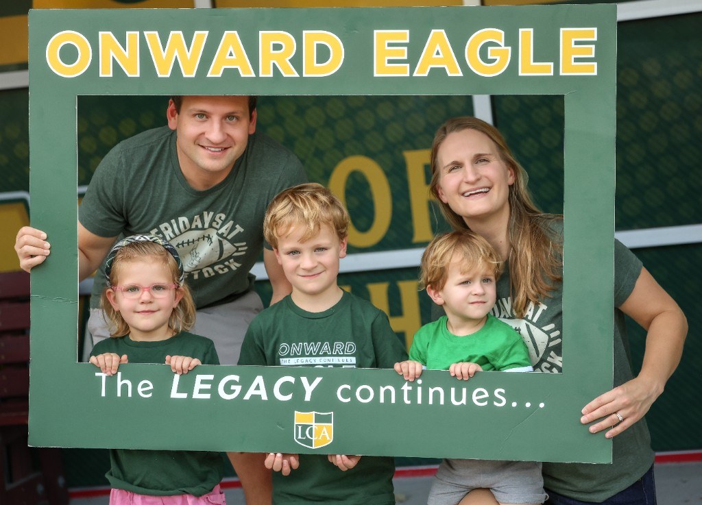 Onward Eagle family smiling through the Legacy frame