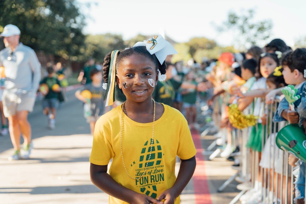 Students high-fiving the crowd during the Homecoming parade