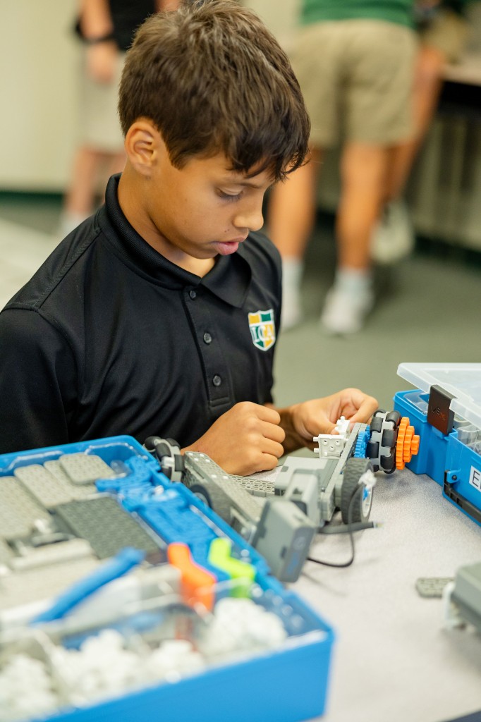 Middle school student building a robotics project